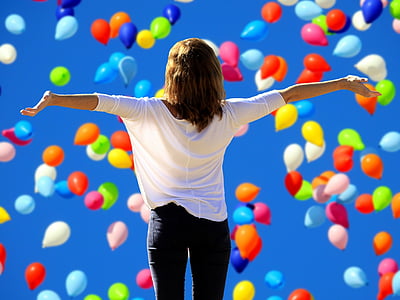 woman in white blouse under assorted-color balloons thumbnail