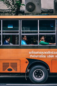 three persons riding on a bus during daytime thumbnail