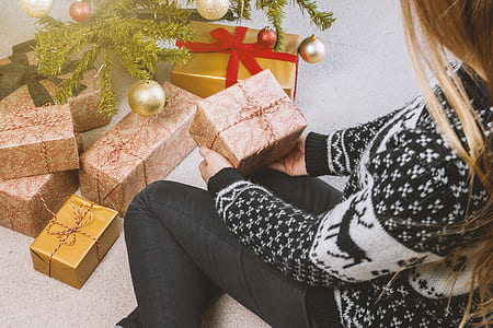 Woman in Sweatshirt and Jeans Holding a Gift Box thumbnail