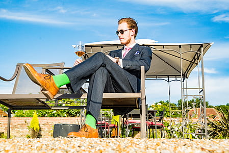 man sitting on chair while crossing his legs thumbnail