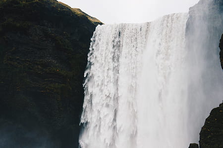 waterfalls surrounded by cliff thumbnail