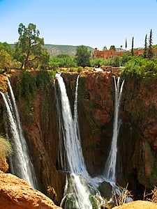 waterfalls near concrete building at daytime thumbnail