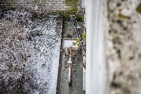 aerial photo of bicycle parked beside the wall thumbnail