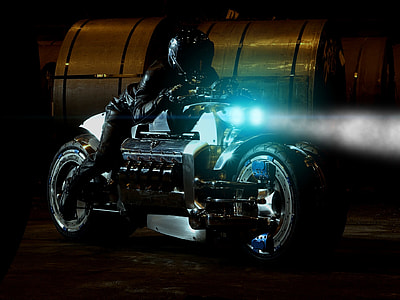 person in black leather jacket riding on black and gray sports bike during nighttime thumbnail