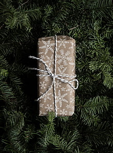gray and white gift box on green holiday tree thumbnail