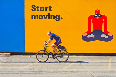 man wearing blue shirt rides mountain bike during daytime thumbnail