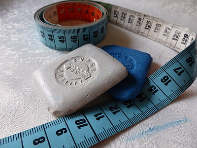 blue tape measure on top of white textile thumbnail
