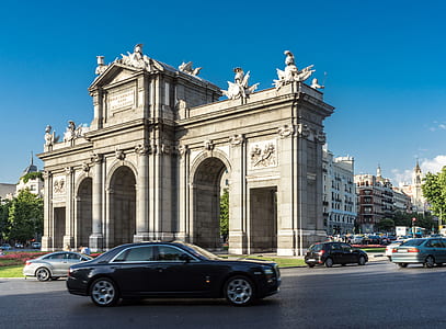 black sedan parked near building thumbnail