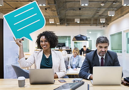 smiling woman sitting at desk beside man thumbnail