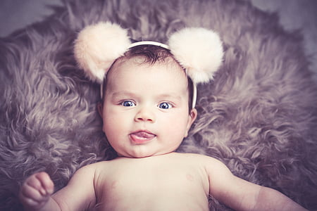 baby with white mickey mouse headband posing for photo thumbnail