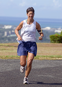 woman running on concrete road during daytime thumbnail