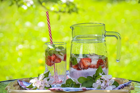 clear glass pitcher beside drinking glass with strawberry juice thumbnail