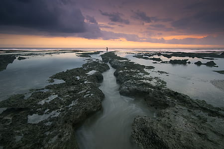 Body of Water Under Grey and Orange Sky during Daytime thumbnail