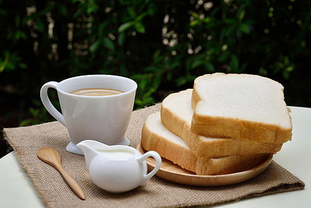 bread near coffee filled mug thumbnail