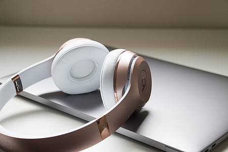 gold Beats by Dr. Dre cordless headphones on laptop computer thumbnail
