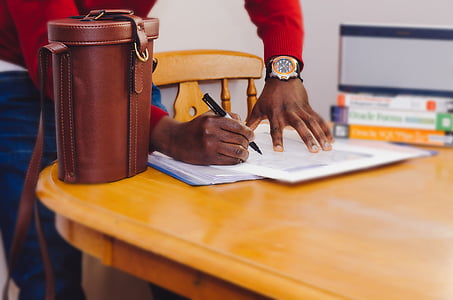 person writing on white paper thumbnail