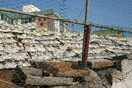 Squid out to dry Opposite the Chain Linked Fence in Mokpo, South Korea thumbnail
