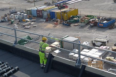 man standing beside railing thumbnail