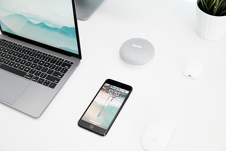 black iPhone 7 near MacBook Pro thumbnail
