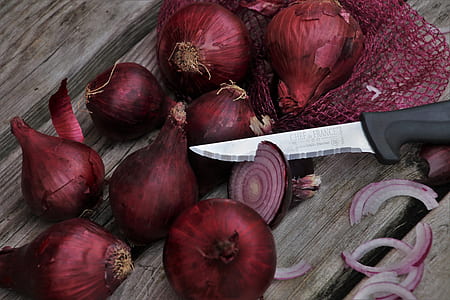 knife on onions close-up photo thumbnail