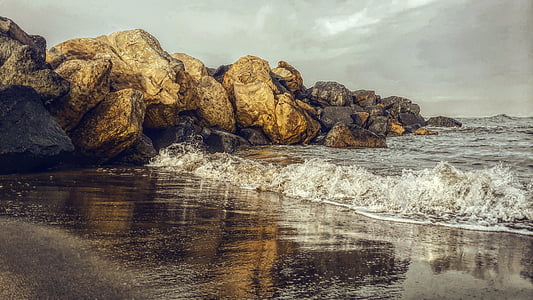 brown rock formation near body of water thumbnail