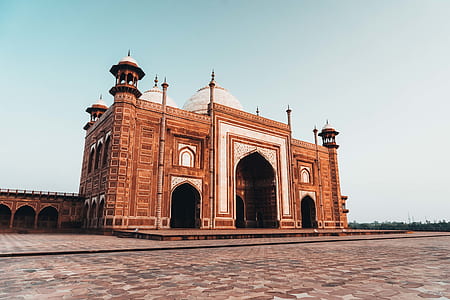 brown and white concrete mosque under blue sky at daytime thumbnail