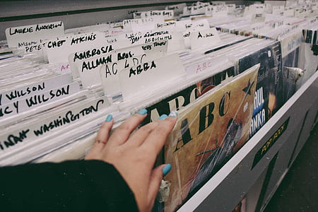 woman holding vinyl sleeves thumbnail