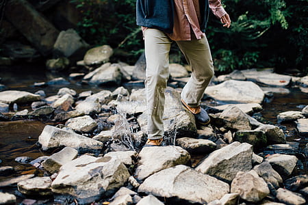 person stepping on gray rocks thumbnail