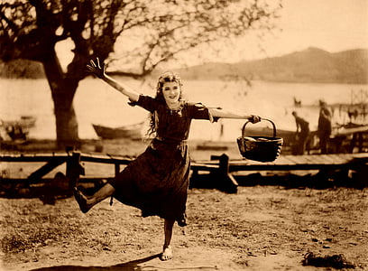 sepia photography of girl in dress holding basket thumbnail