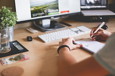 man holding white pen near flat screen computer monitor thumbnail