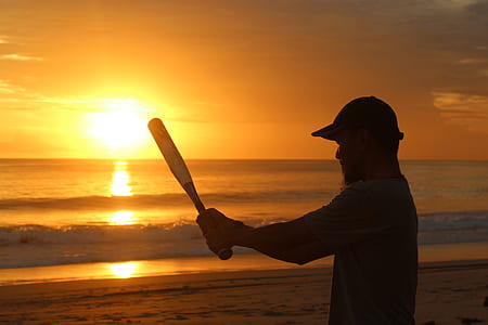 man holding baseball bat on beach thumbnail