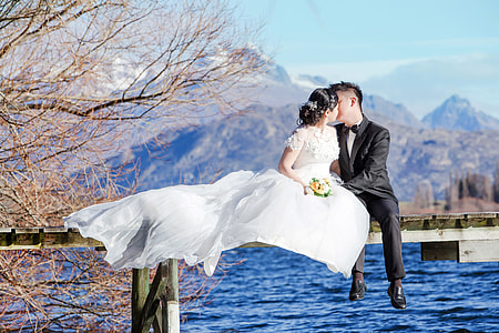 Bride and Groom Kissing by the Lake thumbnail