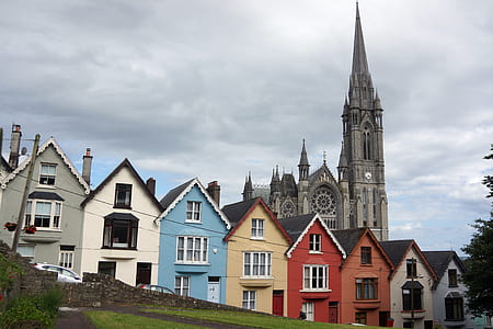 assorted-color concrete house under gray cloudy sky thumbnail