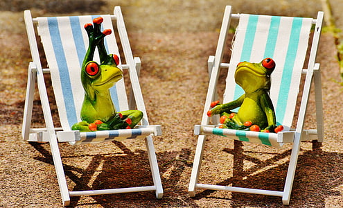 two ceramic frog on teal-and-white wooden beach chairs thumbnail