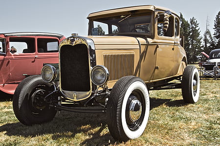 classic brown vehicle parked beside red vehicle at daytime thumbnail