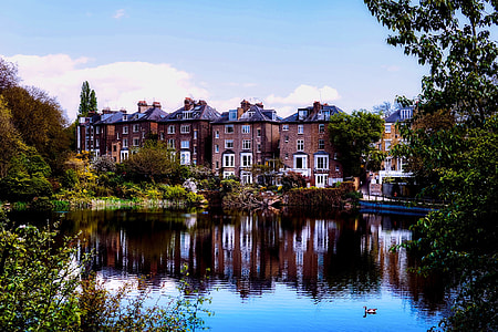 brown concrete building behind pond thumbnail