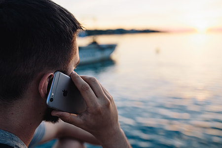 Mobile phone in man's hands near the sea thumbnail