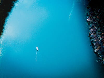 white boat on calm body of water aerial photography thumbnail