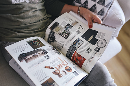 Woman reading a designer magazine on a couch thumbnail