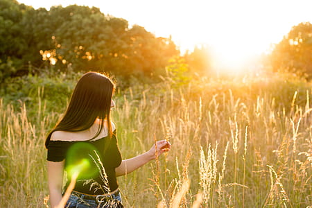 woman wearing black off-shoulder top standing on green grass thumbnail