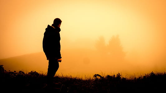 man standing far away from foggy mountain thumbnail