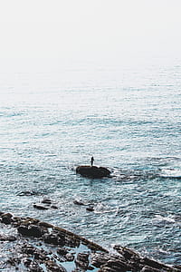 Person Standing on Rock Formation thumbnail