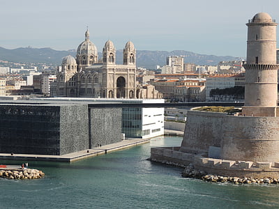 gray concrete building beside body of water thumbnail