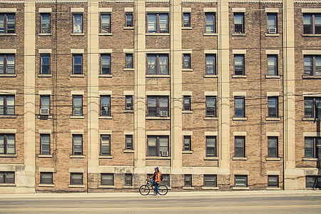 person on bike near building thumbnail