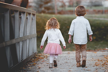 girl beside boy walking at bridge thumbnail