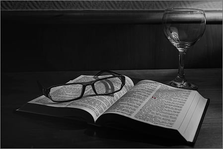 grayscale photo of eyeglasses on top of book thumbnail