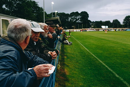 people having conversation while facing green grass field thumbnail