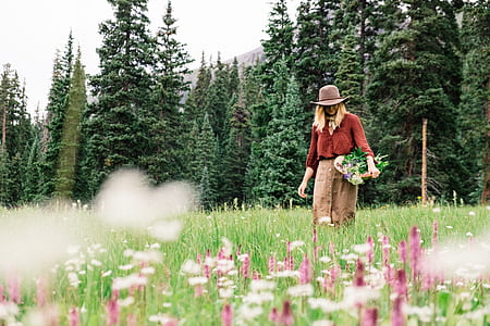 woman walking on green grass field thumbnail