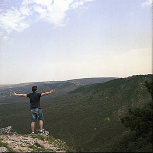 man spreading his arms facing horizon thumbnail
