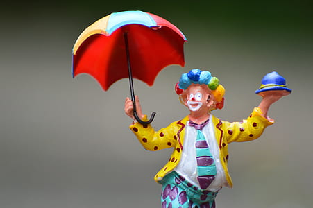 clown holding umbrella ceramic figurine thumbnail